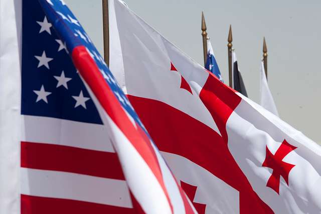 american-and-georgian-flags-fly-side-by-side-during-7f460c